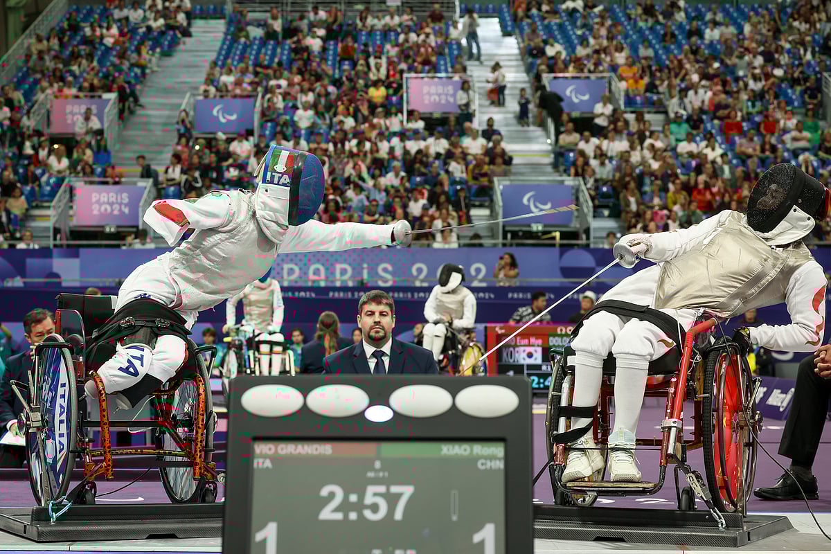 (AP Photo/Thomas Padilla) : Italy's Beatrice Maria Vio Grandis, left, competes against China's Xiao Rong during the women's foil wheelchair fencing semifinal at the 2024 Paralympics, Wednesday, Sept. 4, 2024, in Paris, France. 