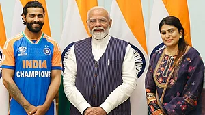 Photo: PTI : Ravindra Jadeja, wife Rivaba (right) with PM Narendra Modi.