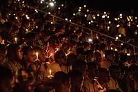 Rwanda: The story Of A Genocide, Gorillas, Gender And Growth via Getty Images : People hold candles during a commemoration ceremony of the 1994 genocide on April 07, 2019 at Amahoro Stadium in Kigali, Rwanda.