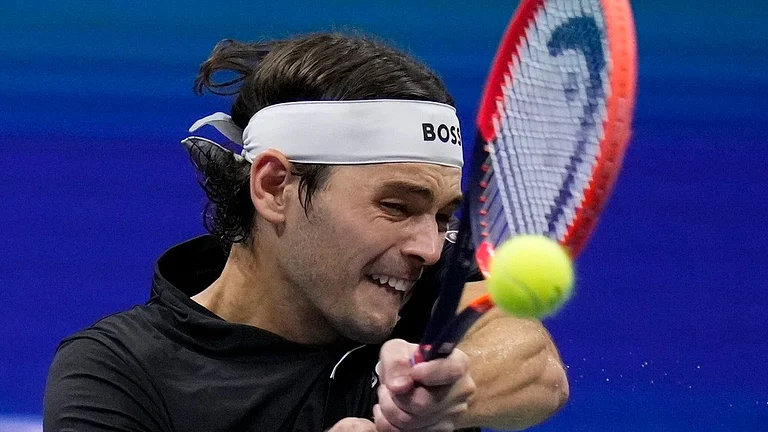 Taylor Fritz returns to Frances Tiafoe during the US Open 2024 men's singles semi-final. - AP/Kirsty Wigglesworth
