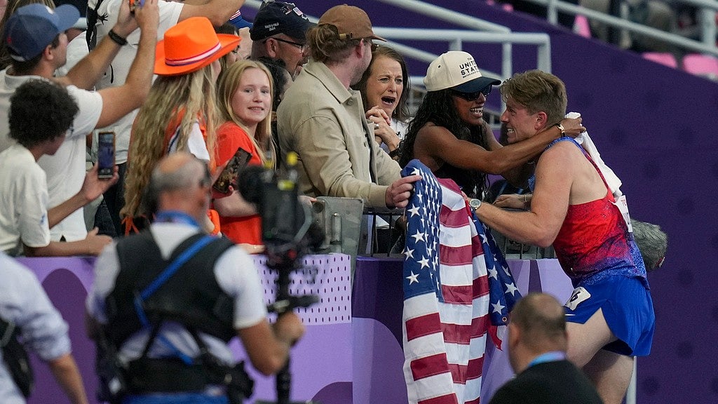 AP/Thibault Camus : Hunter Woodhall (right) hugs his wife and Paris 2024 gold medallist Tara Davis-Woodhall, after himself winning the men's 400 m T62 final at the 2024 Paralympics on Friday (September 6). 