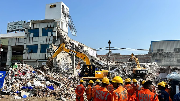 Relief work after building collapse in Lucknow. - PTI