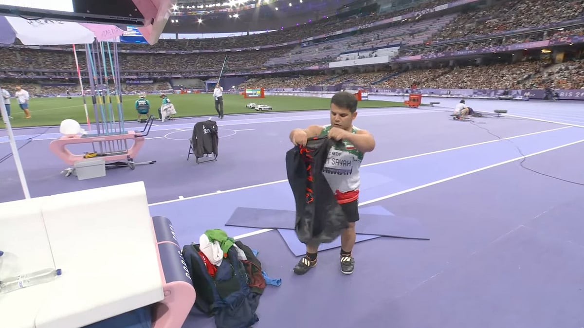 X : Sadegh displaying the black flag at the Paris Paralympics.