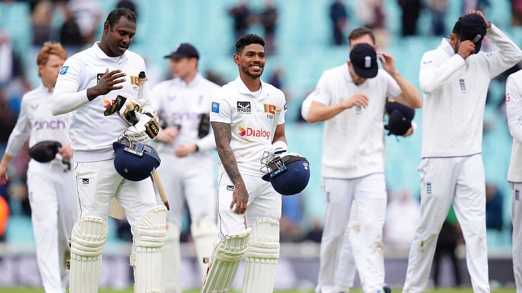 AP/John Walton : Sri Lanka's Pathum Nissanka, centre, leaves the field with Angelo Matthews after hitting the winning runs as Sri Lanka beat England by eight wickets on day four of the third Test at The Oval, in London.