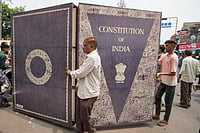 Photo: AP/Ajit Solanki : Dalits carry a huge replica of the Indian constitution during a nationwide strike against the Supreme Court's decision on affirmative action for people in the lowest castes in Ahmedabad.