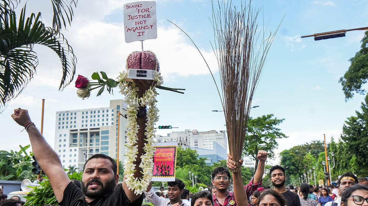 Junior doctors holding broom shout slogans as they march towards Swasthya Bhawan