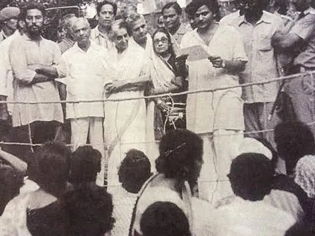 JNU student leader Sitaram Yechury reading a memorandum against Indira Gandhi, as she watches.