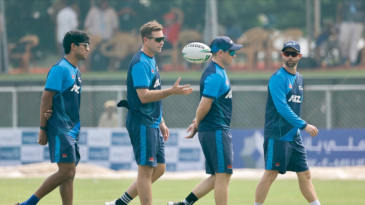 AP Photo : New Zealand's captain, Tim Southee, second left, along with his teammates, inspects the field as the toss is delayed due to a wet outfield on the first day of the Test match.