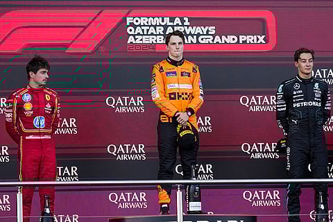 Azerbaijan GP 2024: Second-placed Ferrari driver Charles Leclerc of Monaco, first-placed McLaren driver Oscar Piastri of Australia, and third-placed Mercedes driver George Russell of Britain
