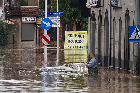 European Floods 2024: A man stands in waist-deep water in the town of Kłodzko, south-western Poland