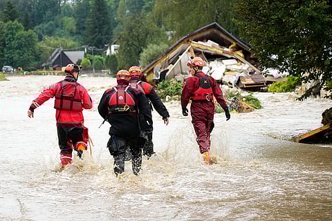 European Floods 2024: Firefighters walk through a flooded road in Chechia