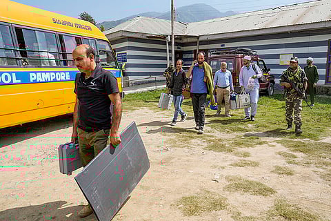J&K Polls 2024, South Kashmir: Polling officials with EVMs and other election material arrive at a polling station