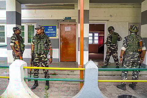 J&K Polls 2024, South Kashmir: Security personnel stand guard at a polling station in Pulwama