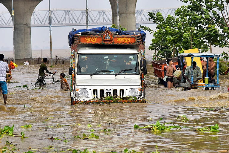 Vehicles pass through a waterlogged road in Patna - | Photo: PTI