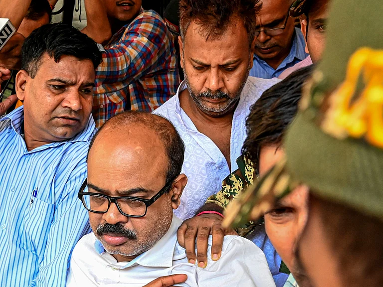 Arrested Tala Police Station Officer-in-Charge Abhijit Mondal (front) and former Principal Sandip Ghosh (back) being taken by the CBI officials to a court. - PTI