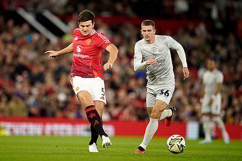 EFL Cup, Manchester United vs Barnsley: Manchester United's Harry Maguire, left, and Barnsley's Max Watters battle for the ball