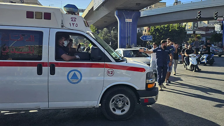 An ambulance carries wounded people after pagers explosion. - AP