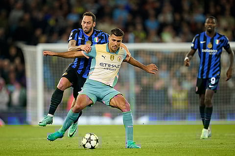 UEFA Champions League, Manchester City vs Inter Milan: Manchester City's Rodrigo, right, is challenged by Inter Milan's Hakan Calhanoglu