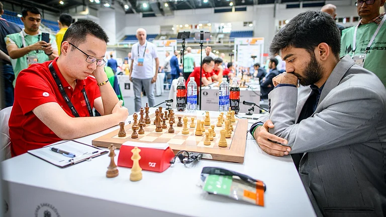 D Gukesh against Wei Yi at the Chess Olympiad. - X/Chessbase India