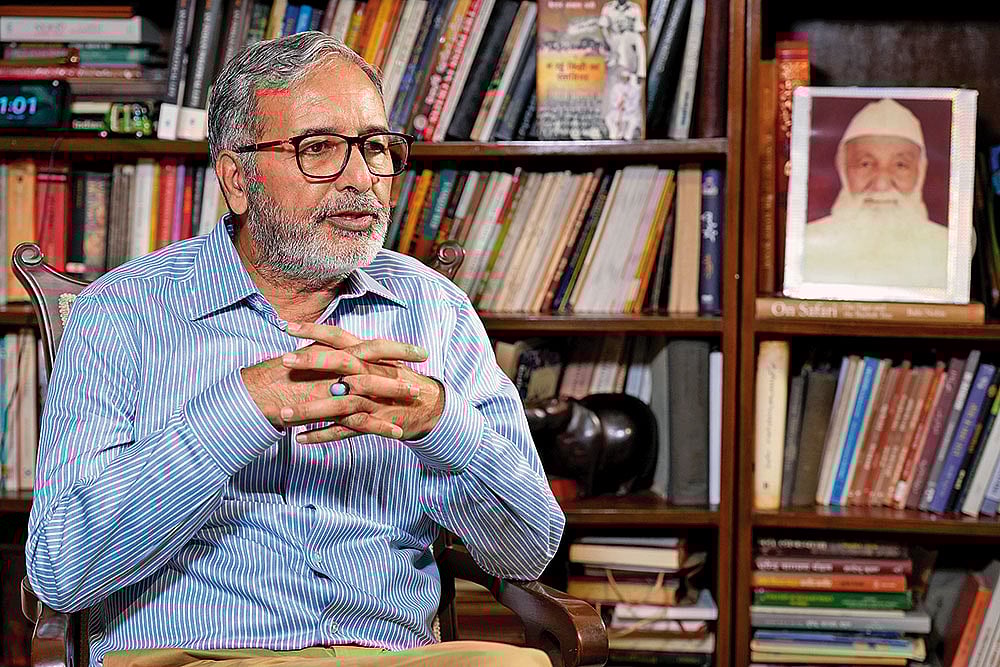 Photo: Suresh K. Pandey : In Living Memory: Qurban Ali at home with his father Captain Abbas Ali’s photo in the background
