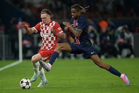 UEFA Champions League, PSG vs Girona: Girona's Viktor Tsygankov, left, and PSG's Bradley Barcola fight for the ball