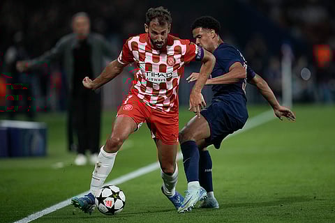UEFA Champions League, PSG vs Girona: Girona's Cristhian Stuani, left, and PSG's Warren Zaire-Emery fight for the ball