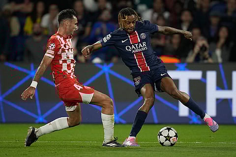 UEFA Champions League, PSG vs Girona: Girona's Arnau Martinez, left, and PSG's Bradley Barcola fight for the ball