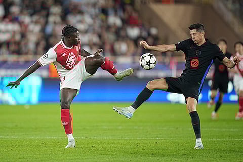 UEFA Champions League, Monaco and Barcelona: Barcelona's Robert Lewandowski, right, fights for the ball with Monaco's Mohammed Salisu