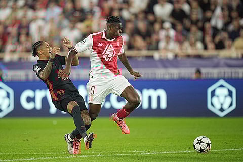 UEFA Champions League, Monaco and Barcelona: Barcelona's Raphinha, left, is challenged by Monaco's Wilfried Singo
