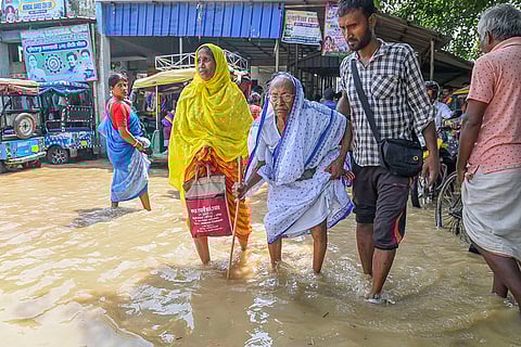 Bengal floods: People wade through a waterlogged road in in Nadia