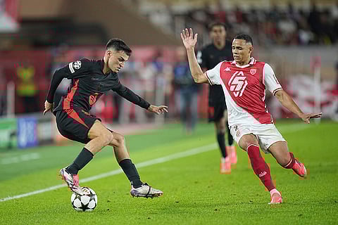 UEFA Champions League, Monaco and Barcelona: Barcelona's Pedri, left, controls the ball past Monaco's Vanderson