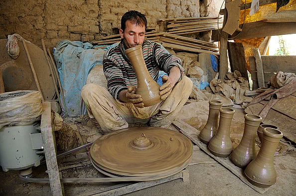  (Photo via Getty Images) : A potter works on an earthen Tumbaknari, a goblet drum traditional to Jammu and Kashmir, at a workshop on April 25, 2018 in Srinagar, India. 