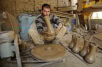 (Photo via Getty Images) : A potter works on an earthen Tumbaknari, a goblet drum traditional to Jammu and Kashmir, at a workshop on April 25, 2018 in Srinagar, India. 