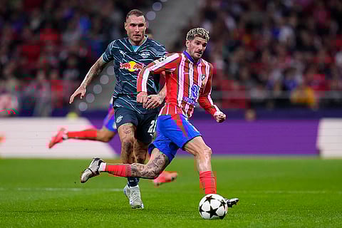 UEFA Champions League, RB Leipzig vs Atletico Madrid: Atletico Madrid's Rodrigo De Paul, right, runs with the ball with Leipzig's David Raum