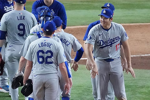 Dodgers vs Marlins Baseball: Shohei Ohtani, right, of Japan, congratulates teammates after the game