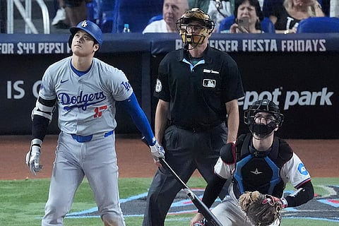 Dodgers vs Marlins Baseball: Shohei Ohtani, left, of Japan, watches the ball as he hits a home run