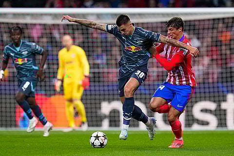 UEFA Champions League, RB Leipzig vs Atletico Madrid: Leipzig's Benjamin Sesko, left, vies for the ball with Atletico Madrid's Robin Le Normand