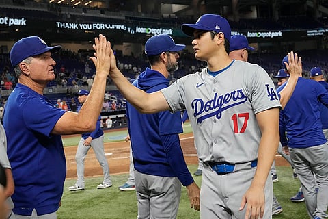 Dodgers vs Marlins Baseball: Los Angeles Dodgers' Shohei Ohtani (17) is congratulated by a coach at the end of the game