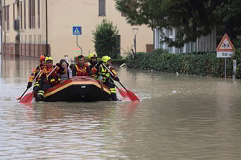 Central Europe Floods: Firefighters use a dingy boat to evacuate civilians in Italy