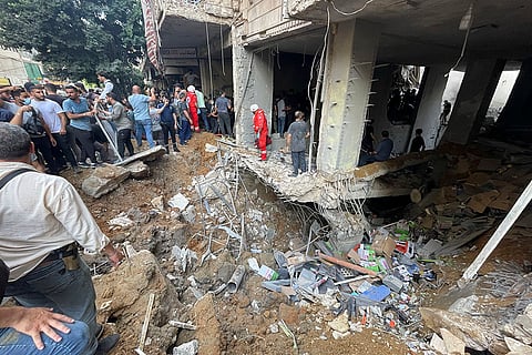 Lebanon Mideast Tensions: Residents and rescuers gather at the scene