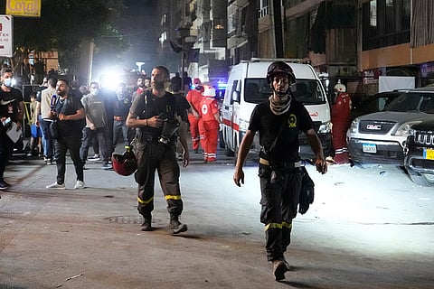 Lebanon Mideast Tensions: Rescuers work at the scene of missile strike