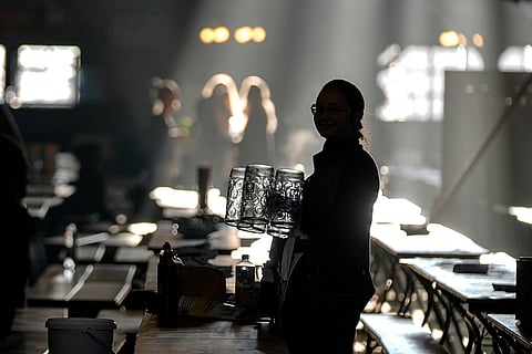 Oktoberfest Opening: A waitress prepares beer mugs in the Augustiner marquee