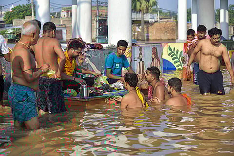 Bihar Flood: Devotees at a temple waterlogged in flood water