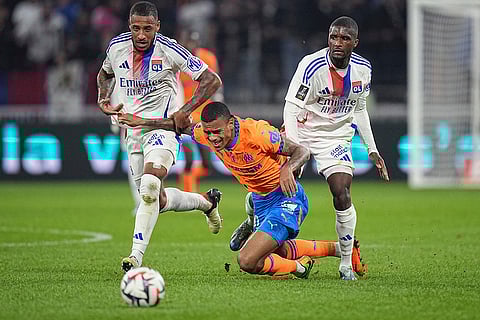 Ligue 1 Soccer, Marseille vs Lyon: Marseille's Mason Greenwood, center, challenges Lyon's Corentin Tolisso and Clinton Mata for the ball