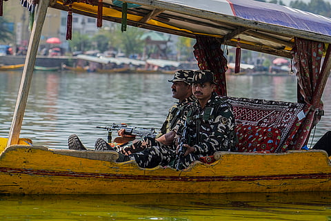 Soldiers guard during an election rally at Dal Lake