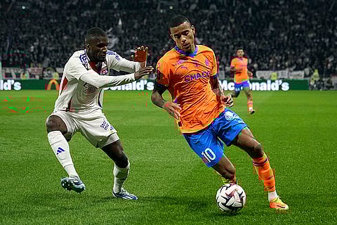 Ligue 1 Soccer, Marseille vs Lyon: Marseille's Mason Greenwood, right, challenges Lyon's Clinton Mata for the ball