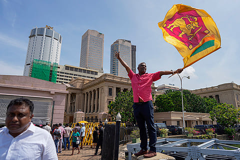 Sri Lanka elections result 2024: A supporter waves Sri Lankan flag out side president's office in Colombo