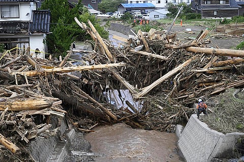 Japan Floods: Debris and driftwoods are piled near damaged houses along a river running through Wajima