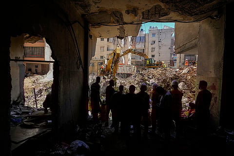 Emergency workers use excavators to clear the rubble at the site of Friday's Israeli strike in Beirut's southern suburbs, Lebanon, Monday, Sept. 23, 2024.