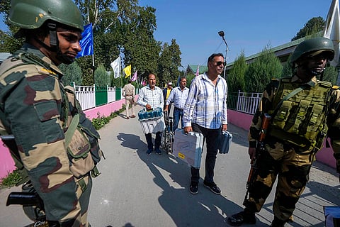 J&K Polls 2024: Indian paramilitary soldiers guard outside a distribution center
